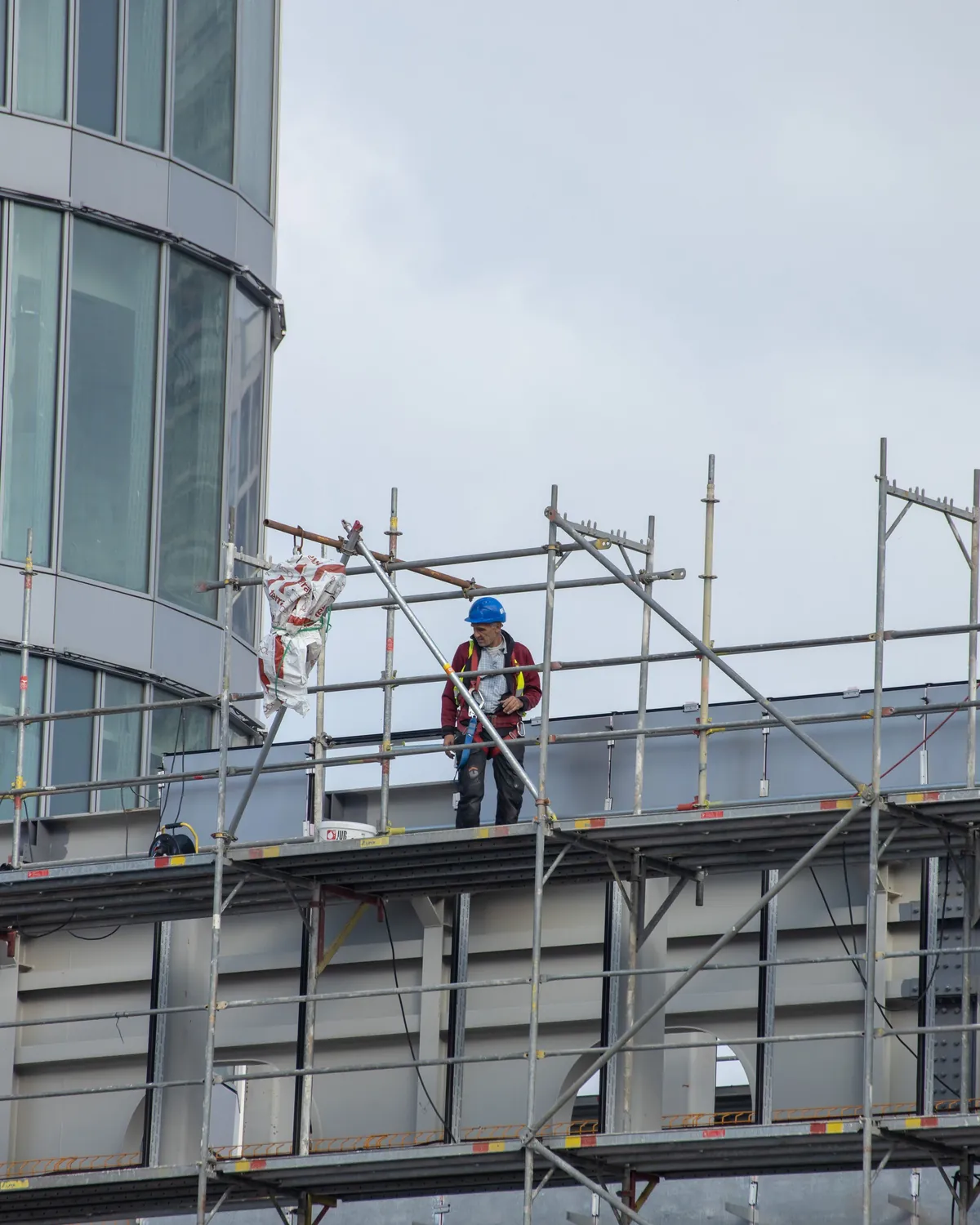 Worker on scaffolding at a high-rise building