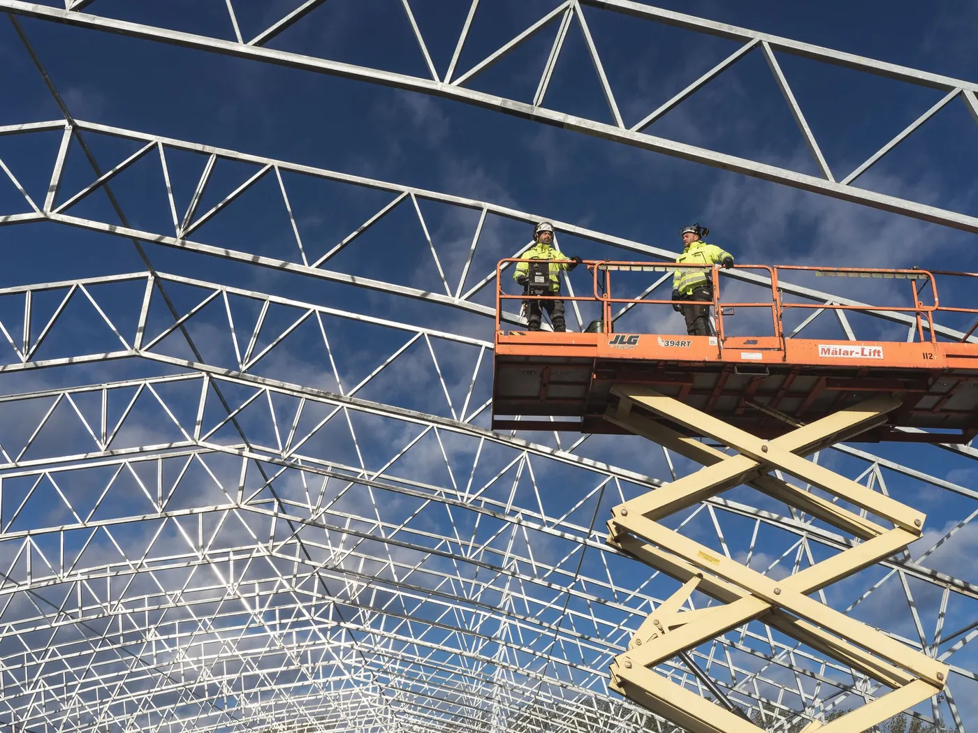 Workers on a scissor lift using professional access equipment