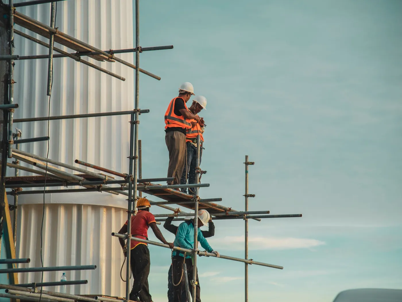 Installers working from scaffolding on a building exterior