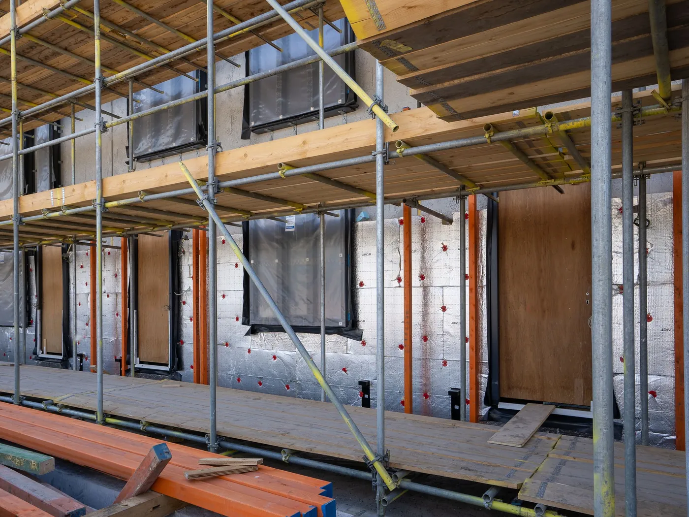 Scaffolding and exterior insulation going onto a building wall