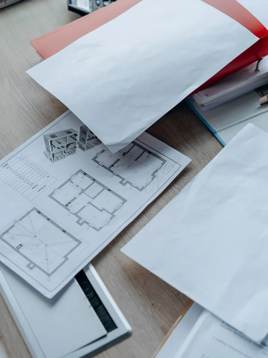 Floor plans and project paperwork on a desk